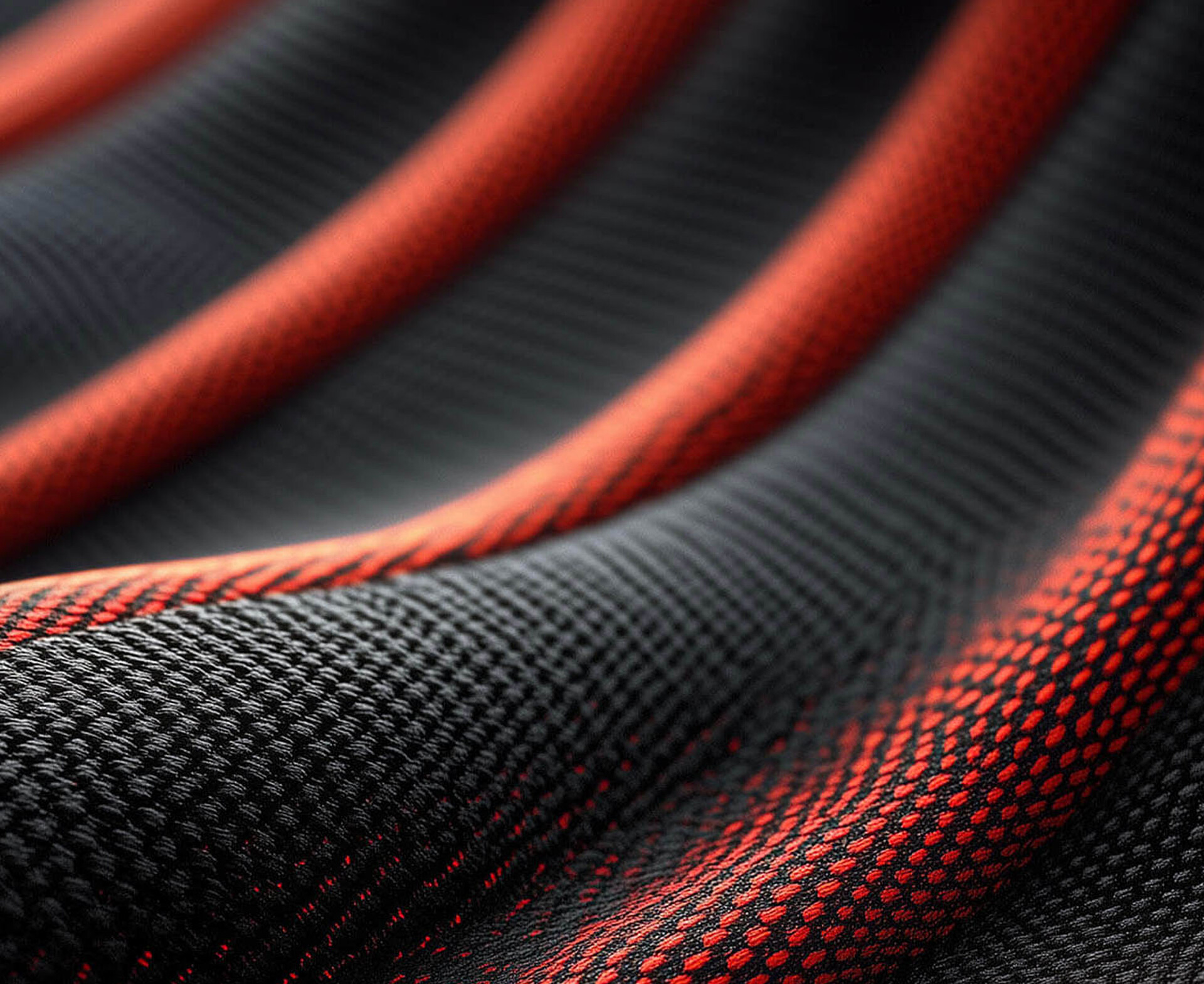 Technische Textilien aus dem Recycling-Granulat rPET bieten hohe Designvielfalt. Dieses Beispiel zeigt einen sportlichen Sitzbezug in rot-schwarz